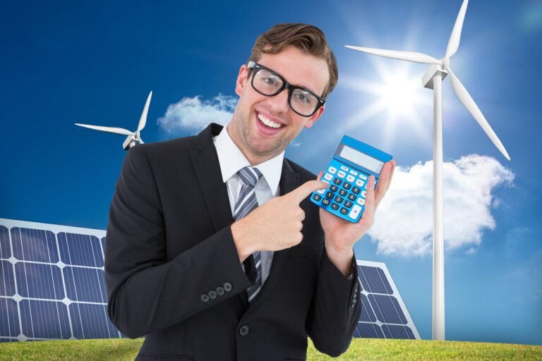 happy man holding calculator solar panel background
